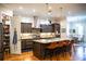 Gourmet kitchen with stainless steel appliances, granite countertops, and a large island with seating at 329 W Grace St, Punta Gorda, FL 33950