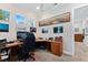 Bright home office with multiple windows, custom desk, and stylish decor at 329 W Grace St, Punta Gorda, FL 33950
