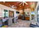 This outdoor kitchen offers a built-in grill, wooden cabinets, TV, and seating under a wood ceiling at 329 W Grace St, Punta Gorda, FL 33950
