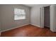 Cozy bedroom with neutral color palette, laminate floors, closet, and natural light at 406 Merlin Ct, Brandon, FL 33510