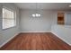 Open dining area with laminate wood floors and a stylish chandelier, perfect for Gathering meals at 406 Merlin Ct, Brandon, FL 33510