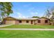 Charming single-story home featuring a metal roof, stone accents, and a well-maintained front yard at 406 Merlin Ct, Brandon, FL 33510