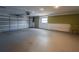 Spacious two-car garage with a large window and neutral colored walls at 406 Merlin Ct, Brandon, FL 33510