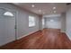 Bright living room featuring new laminate floors, neutral paint, and plenty of natural light from large window at 406 Merlin Ct, Brandon, FL 33510