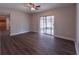 Spacious living room featuring laminate wood floors and a sliding glass door that fills the room with natural light at 406 Merlin Ct, Brandon, FL 33510