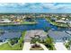 Beautiful waterfront home with lush landscaping and a circular driveway in a desirable neighborhood at 414 Caicos Dr, Punta Gorda, FL 33950