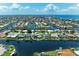 Stunning aerial view of waterfront homes in a coastal community, each with private boat docks and canal access at 414 Caicos Dr, Punta Gorda, FL 33950