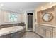 Elegant bathroom featuring dual vanities, shower, and a standalone tub at 414 Caicos Dr, Punta Gorda, FL 33950