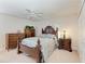 Elegant bedroom features a wooden bed frame, ceiling fan, and ample natural light at 414 Caicos Dr, Punta Gorda, FL 33950
