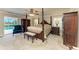 Elegant bedroom featuring a four-poster bed, carpeted floors, and a ceiling fan at 414 Caicos Dr, Punta Gorda, FL 33950