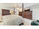 Bedroom with a decorative four-poster bed, TV, and neutral carpeted floors at 414 Caicos Dr, Punta Gorda, FL 33950