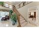 Foyer with staircase and a glimpse into a well-lit living space and bedroom at 414 Caicos Dr, Punta Gorda, FL 33950