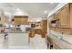 Well-equipped kitchen with granite countertops, wooden cabinets, and a breakfast bar at 414 Caicos Dr, Punta Gorda, FL 33950