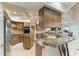 Gourmet kitchen with granite counters, stainless appliances, and a breakfast bar at 414 Caicos Dr, Punta Gorda, FL 33950