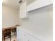 Bright laundry room featuring storage cabinets, a sewing machine and neutral-tiled floors at 414 Caicos Dr, Punta Gorda, FL 33950