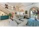 Open living room featuring a staircase, comfortable seating, and elegant decor at 414 Caicos Dr, Punta Gorda, FL 33950