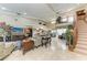 Spacious living room with high ceilings, staircase, and elegant decor, perfect for entertaining at 414 Caicos Dr, Punta Gorda, FL 33950