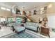 Inviting living room with a view of the pool, comfortable seating, and a grand staircase at 414 Caicos Dr, Punta Gorda, FL 33950