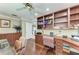 Well-designed office with custom built-ins and hardwood floors, providing an ideal space for work and study at 414 Caicos Dr, Punta Gorda, FL 33950