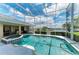 Enclosed pool and jacuzzi with views of the water, perfect for relaxation and entertainment at 414 Caicos Dr, Punta Gorda, FL 33950