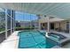 Inviting screened-in pool with attached hot tub and ample patio space for outdoor enjoyment and relaxation at 414 Caicos Dr, Punta Gorda, FL 33950