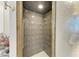 Modern shower featuring gray tiled walls and a glass door at 414 Caicos Dr, Punta Gorda, FL 33950