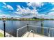 Picturesque waterfront view of neighboring homes from a private dock with lush landscaping and tranquil canal at 414 Caicos Dr, Punta Gorda, FL 33950