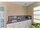 Convenient wet bar featuring tile accents, sink, and ample storage space in the screened lanai area at 414 Caicos Dr, Punta Gorda, FL 33950