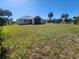 Exterior back view of house, spacious backyard and a screened porch at 4390 Wischamper St, Port Charlotte, FL 33948