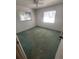 Standard bedroom showcasing a ceiling fan, carpet flooring, and natural light from windows at 4390 Wischamper St, Port Charlotte, FL 33948