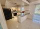 Traditional kitchen featuring white cabinets, black refrigerator, and neutral countertops at 4390 Wischamper St, Port Charlotte, FL 33948