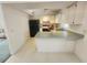 Bright kitchen featuring tile floors, a breakfast bar, and appliances at 4390 Wischamper St, Port Charlotte, FL 33948