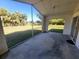 Screened porch with a view of the backyard and surrounding trees at 4390 Wischamper St, Port Charlotte, FL 33948
