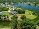Aerial view of property featuring home, pool, and surrounding lake and neighborhood at 501 Fairmont Ter, Port Charlotte, FL 33954