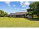 Large backyard features a screened-in pool and lanai surrounded by mature trees at 501 Fairmont Ter, Port Charlotte, FL 33954