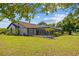 Manicured backyard with a screened-in pool and lanai surrounded by manicured tropical landscaping at 501 Fairmont Ter, Port Charlotte, FL 33954