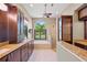 Elegant bathroom with granite countertops, dark wood cabinets, soaking tub, and walk-in shower at 501 Fairmont Ter, Port Charlotte, FL 33954