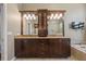 Bathroom vanity with double sinks, granite countertop, dark wood cabinets, and decorative mirror at 501 Fairmont Ter, Port Charlotte, FL 33954