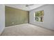 Bedroom featuring carpet floors, ceiling fan, window view, and painted wall at 501 Fairmont Ter, Port Charlotte, FL 33954