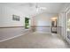 Bedroom with carpet flooring, ceiling fan, window view, and a bathroom at 501 Fairmont Ter, Port Charlotte, FL 33954