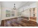 Dining room with hardwood floors and lots of natural light, adjoining sitting room with stone fireplace at 501 Fairmont Ter, Port Charlotte, FL 33954