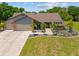 Charming single-story home showcasing well-manicured landscaping, palm trees and a multi-car garage at 501 Fairmont Ter, Port Charlotte, FL 33954