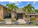 Charming front entrance with landscaped garden beds and palm trees, giving the home great curb appeal at 501 Fairmont Ter, Port Charlotte, FL 33954