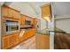 Modern kitchen with wooden cabinets, stainless steel appliances, and a dark countertop at 501 Fairmont Ter, Port Charlotte, FL 33954