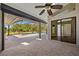 Covered lanai boasts textured concrete floors, ceiling fan, and access to a screened-in pool at 501 Fairmont Ter, Port Charlotte, FL 33954