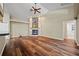 Bright living room featuring wood floors, stone fireplace, and ceiling fan at 501 Fairmont Ter, Port Charlotte, FL 33954