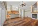 Spacious living room featuring wood floors, skylights, fireplace, and an open floor plan at 501 Fairmont Ter, Port Charlotte, FL 33954
