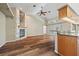 Open-concept living space with hardwood floors, stone fireplace, and breakfast bar overlooking the kitchen at 501 Fairmont Ter, Port Charlotte, FL 33954