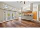 Living room with hardwood floors, skylights, and modern, open kitchen with stainless appliances at 501 Fairmont Ter, Port Charlotte, FL 33954