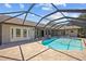 Spacious concrete patio with a screened-in pool and backyard with views of surrounding landscaping at 501 Fairmont Ter, Port Charlotte, FL 33954